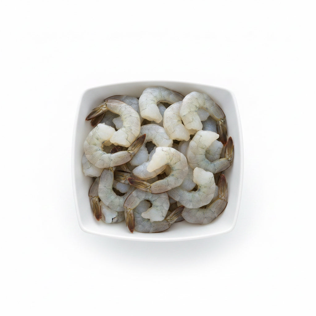 headless peeled and deveined prawns in a bowl with a white background